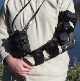 Arlene wearing arm brace, shoulder pad, and camera