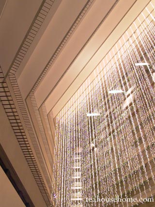 abstract image of white holiday lights hanging from a tiered hotel balcony